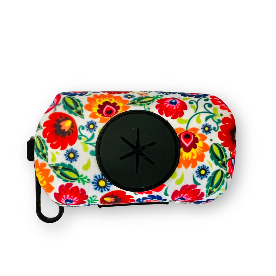 Floral dog waste bag holder by Lucky Love Dog Austin, featuring a secure clip and a large black dispenser opening.