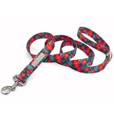 Red poinsettia-themed holiday dog leash by Lucky Love Dog Austin with metal clasp.