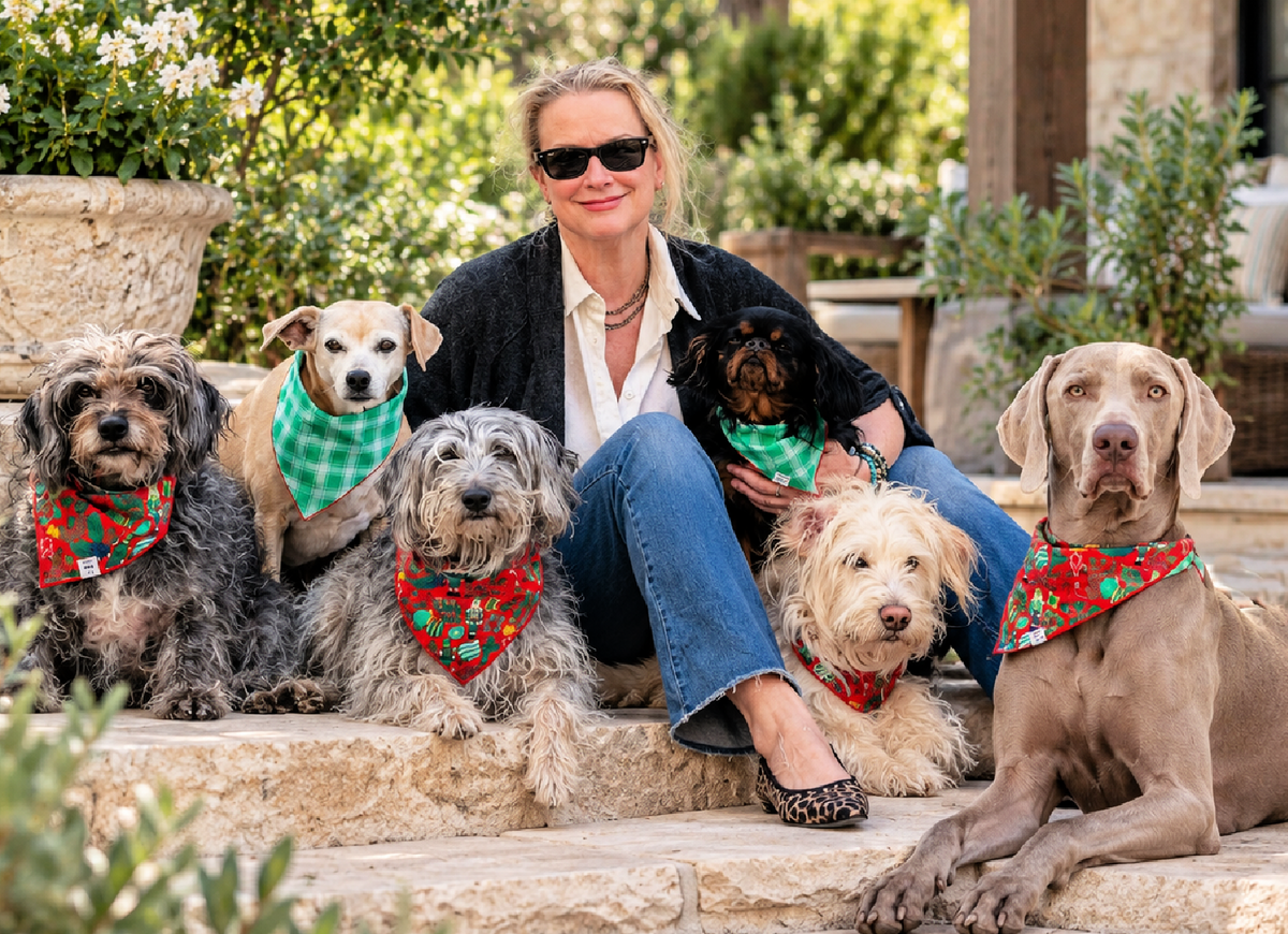 woman with 6 dogs in holiday bandanas