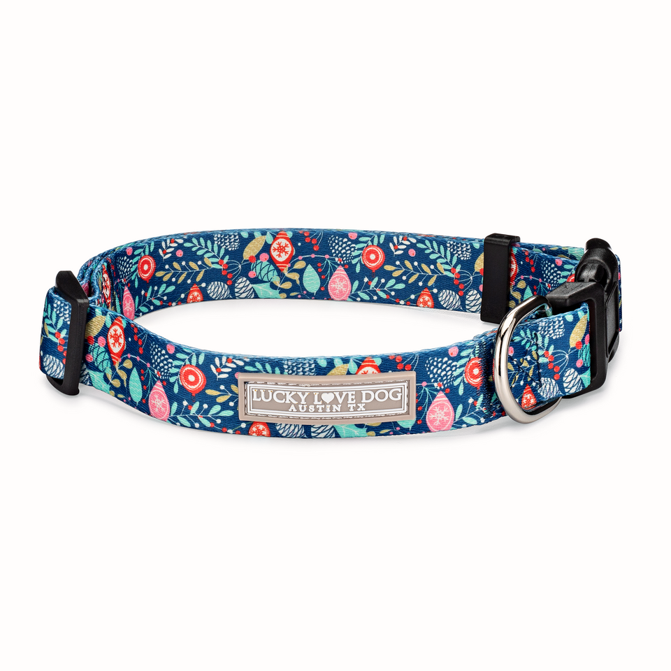 Blue holiday-themed dog collar by Lucky Love Dog Austin with festive ornament and foliage pattern.